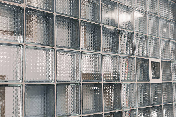 istock A close-up view reveals a glass block wall featuring various textured patterns, allowing natural light to filter through, enhancing the room's contemporary aesthetic 2233471567