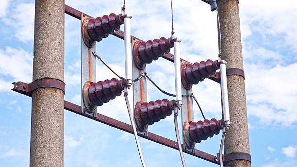 istock Electrical Substation Concrete Utility Pole with Electricity Power Lines and Ceramic Insulators 2233471647