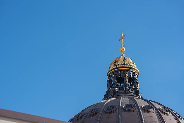istock Golden dome with a cross shines against the clear blue sky. 2233471683