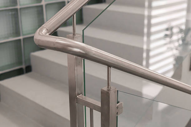 istock A sleek stainless steel railing complements a modern staircase featuring glass panels, showcasing minimalist design in a contemporary setting. The light enhances the clean lines and textures 2233471951