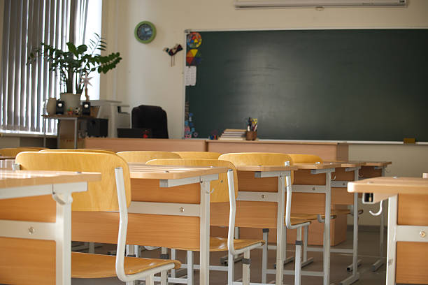 istock The classroom is set for learning with neatly arranged desks and a chalkboard. 2233471960