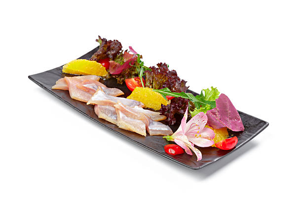 istock Salted herring pieces served with lettuce isolated on white 2233472124