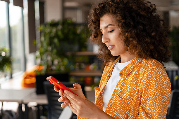 istock Young manager, beautiful woman using smartphone in modern office 2233472339