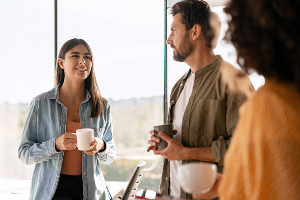 istock Creative business team enjoying coffee break during meeting in modern office 2233472356