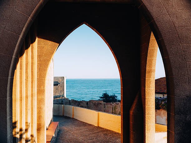 Golden sunrise above the Mediterranean Sea with historic medieval walls of Tossa de Mar, Costa Brava, Catalonia, Spain, popular holiday and photography location.
