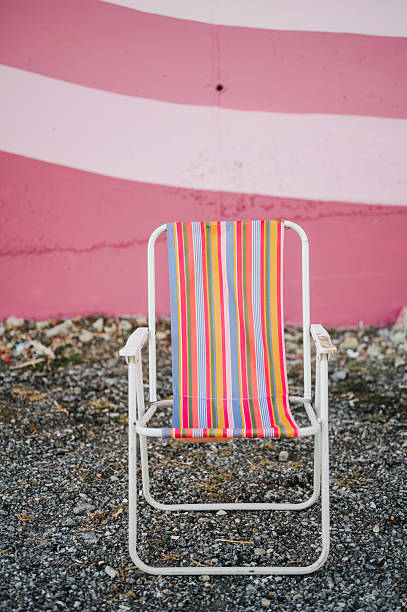 Colorful chair in front of a mural / graffiti wall
