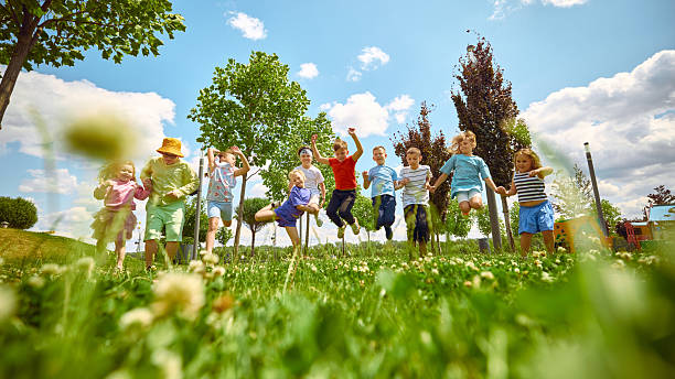 istock Children playing joyfully in sunlit green park 2233473871