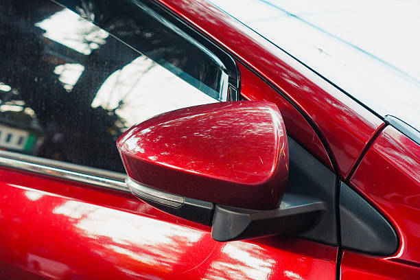 istock Examining Side Mirror of Modern Red Car with Reflections and Styling 2233475360
