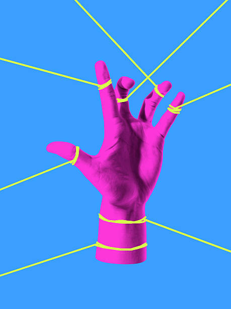 istock Modern composition. Hand trapped in web of strings symbol of restriction stress and struggle 2233475418