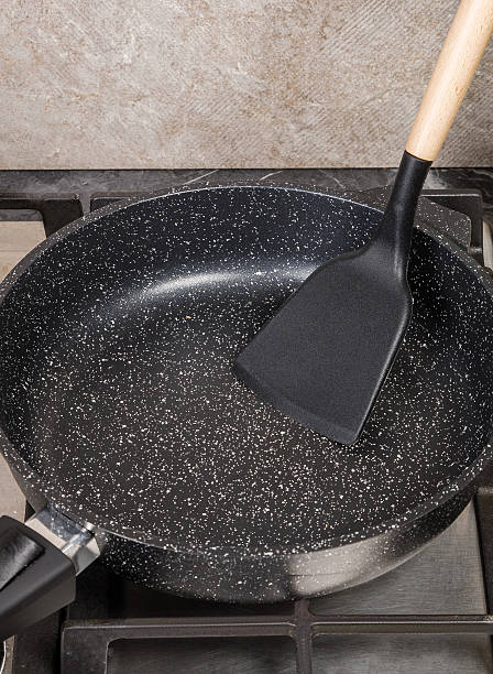 istock A frying pan containing a spatula is currently placed on the stove 2233476091