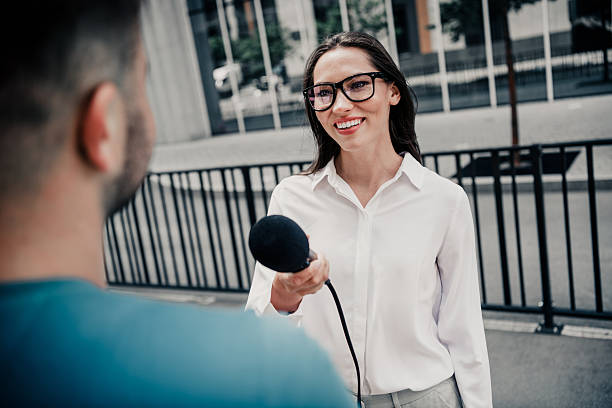 istock Professional female reporter conducting an interview outdoors in a sunny urban environment representing modern communication. 2233476541