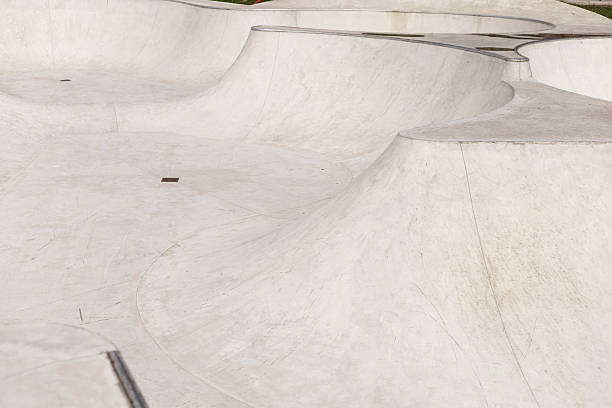 istock The sleek concrete structure features interconnected ramps and bowls tailored for skateboarding activities, illuminated by natural sunlight during midday 2233477265