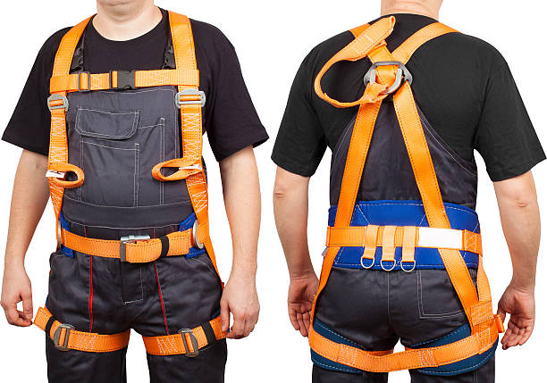 istock Man in orange safety Climbing Harness isolated on white background 2233479124