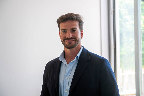 istock Confident businessman smiling in modern office setting 2233481342