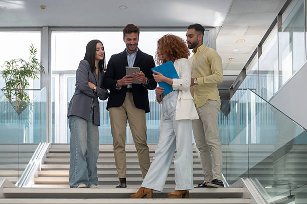 istock Business colleagues collaborating on a digital tablet in modern office 2233481554