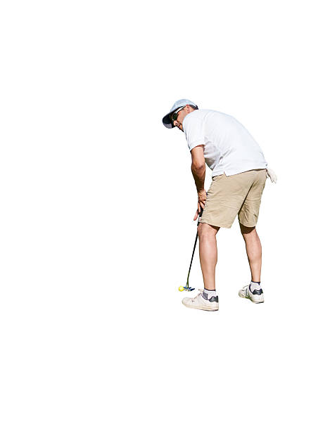 Mature golfer focusing intently on putting the ball on the green, captured from behind against a bright white background, enjoying a sunny day outdoors