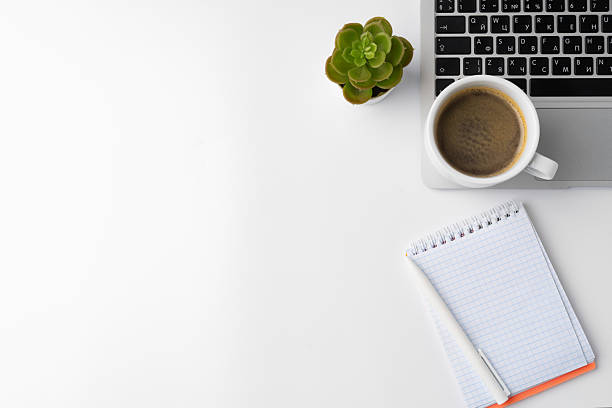 istock Office desk with laptop, blank notebook and coffee cup 2233482898