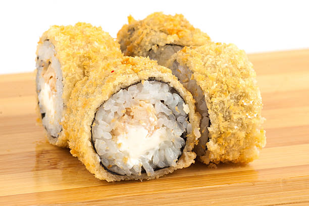 istock Delicious and Crispy Sushi Rolls beautifully arranged on Wooden Platter 2233483379