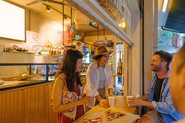 istock Friends eating out in a pizza place 2233484677