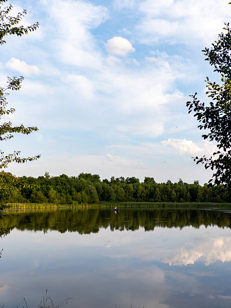 istock A body of water surrounded by trees and clouds 2233485462