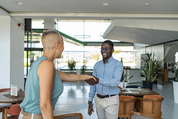 istock Business people shaking hands in modern office lobby 2233485855