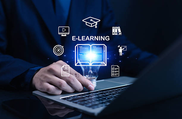 istock Businessman using laptop with glowing e-learning icons, symbolizing online education, digital training, knowledge sharing, virtual classroom, and modern technology learning platform. 2233486689