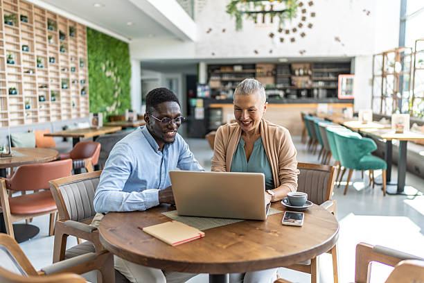 istock Business people working on laptop in a cafe 2233486771