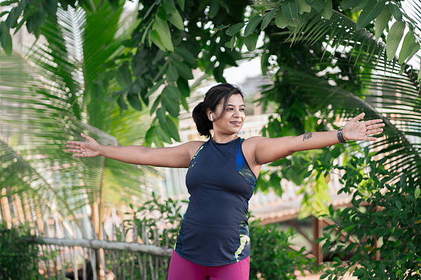 istock Young woman stretching in sunny park 2233488412
