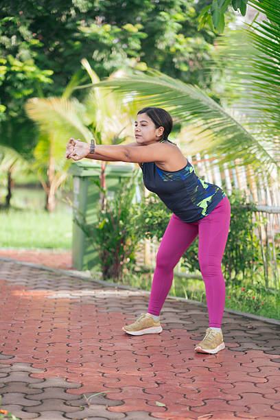 istock Young woman doing pre-workout stretching in nature 2233488582