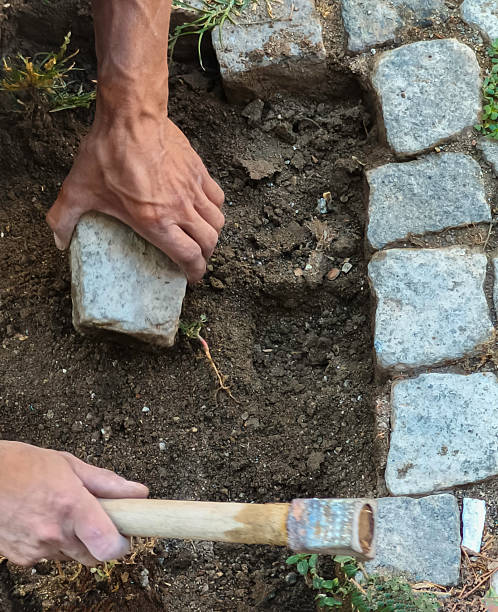 istock The damaged cobblestone road is being repaired 2233489827