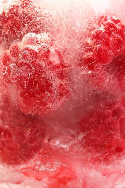 istock Frozen Raspberry in Ice, close up. Refreshing and Vibrant Background for Healthy Summer Food. 2233490421