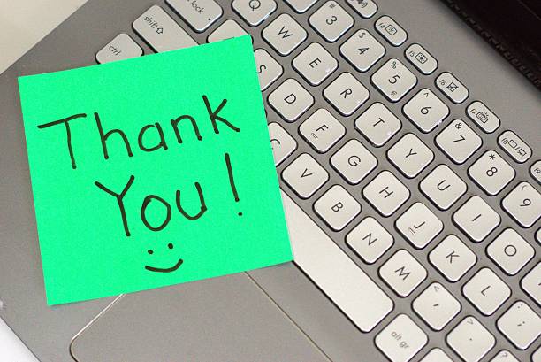 istock Sticky note with thank you message on laptop keyboard 2233491463