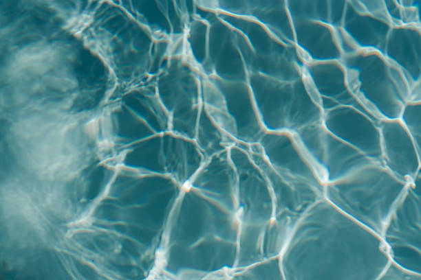 istock Swimming pool with clear blue water with sunlight shadow reflections. Minimalistic aesthetic summer vacation concept background 2233492118
