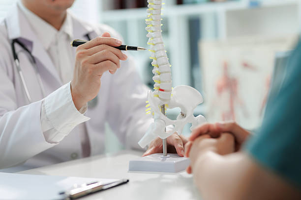 istock Patient consulting doctor about chronic back pain. 2233492464