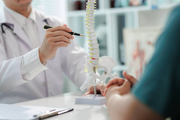 istock Patient consulting doctor about chronic back pain. 2233492468