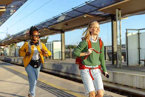 istock Female backpackers rush to the train 2233493934