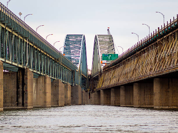 istock Symmetrical View of Twin Bridges Spanning Over a Calm River Stream 2233493973