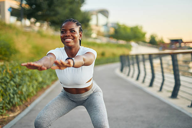 istock Young woman doing squats in a city park 2233494180
