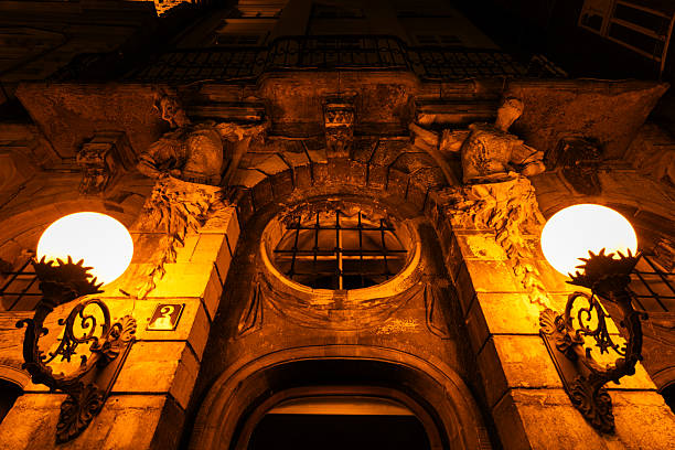 A historic building facade in Lviv illuminated at night.