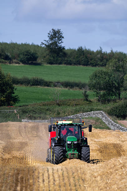 Porreres, Spain; october 31 2021: Green John Deere tractor with black and yellow tires, parked on a sunny morning