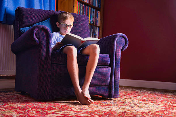 Boy reading in his living room