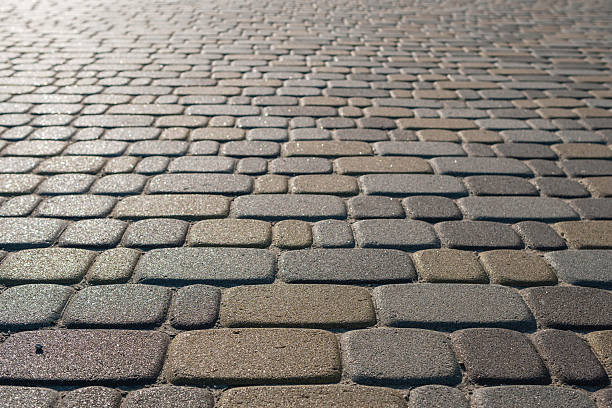 istock Close-up of modern paving stones shining under the sunlight. Background 2233497384