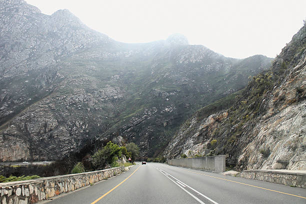 Scenic mountain highway winding through rugged landscape. Perfect for travel, adventure, and road trip content with dramatic mountain views.