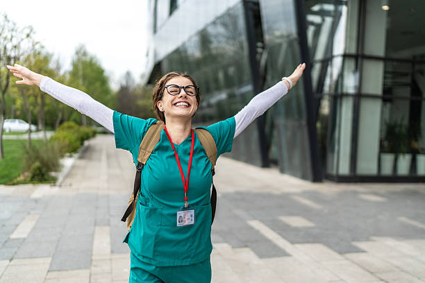 istock Happy young nurse celebrating outside hospital after work 2233499062