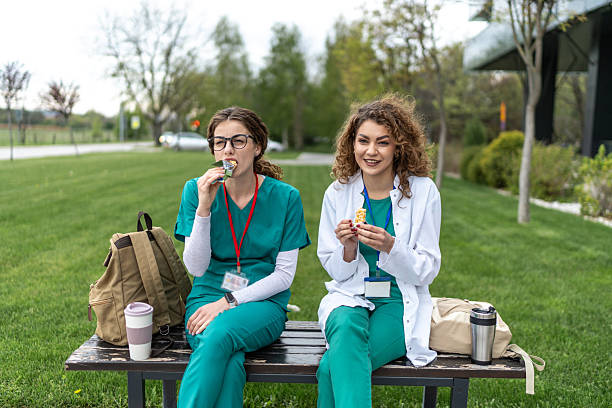 istock Two young doctors enjoying a snack during their break 2233500298