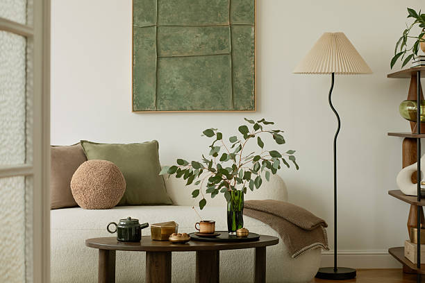 istock Bright and cozy space with white sofa, modern shelving, spring floral arrangement and sculptural ceramics in a nature-inspired setting. 2233501487