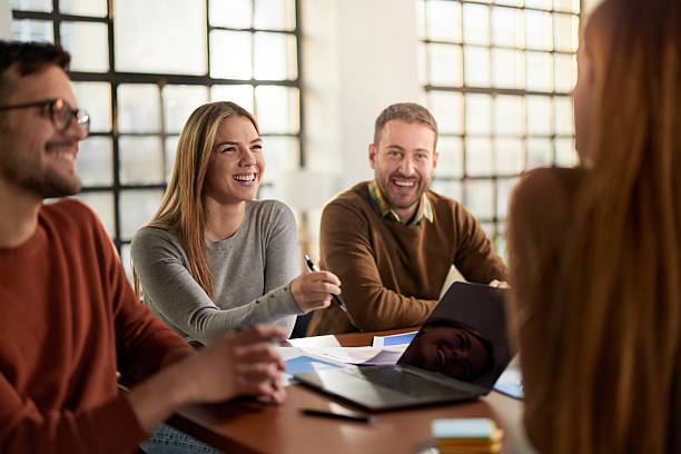 istock Happy creative team talking while having a meeting in the office. 2233502217