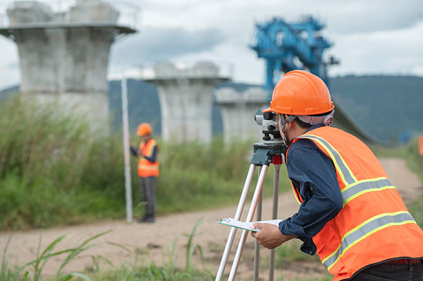 istock Survey technical checking level of site construction with leveling camera digital.  Survey Team Using Leveling Instrument at Elevated High-Speed Railway Construction Site 2233502867