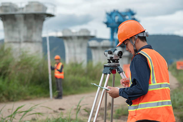 istock Survey technical checking level of site construction with leveling camera digital.  Survey Team Using Leveling Instrument at Elevated High-Speed Railway Construction Site 2233502894