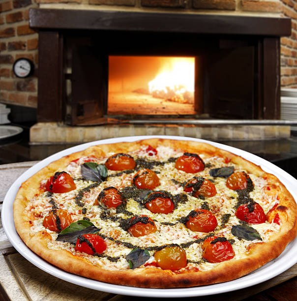 istock Pizzeria, Pizza baked in a wood-fired oven 2233503703
